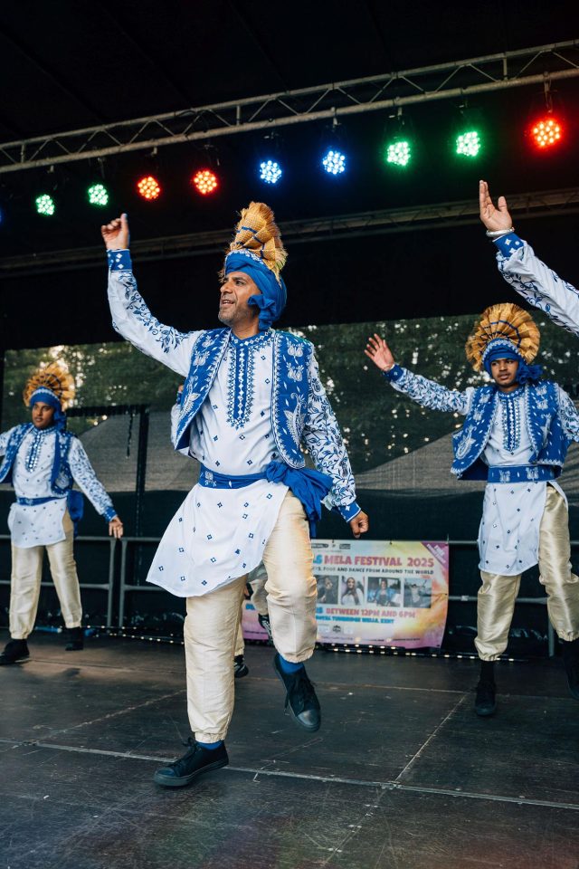 Guests celebrating community arts and cultural diversity with authentic Indian cuisine during the Cohesion Plus event in Kent.